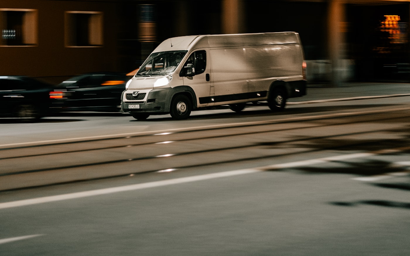 A service van driving at night