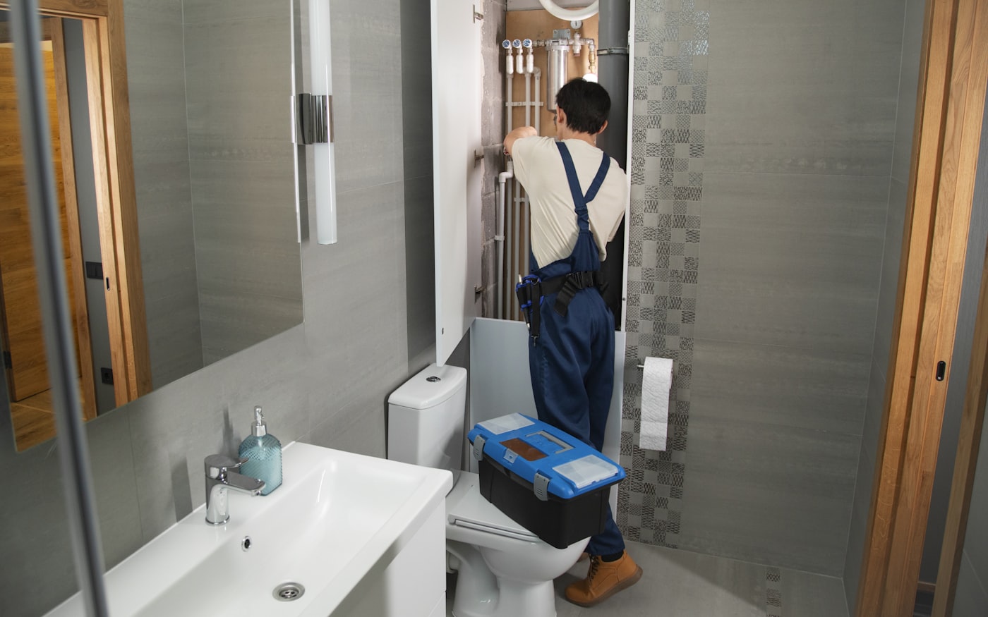 A plumber repairing pipework