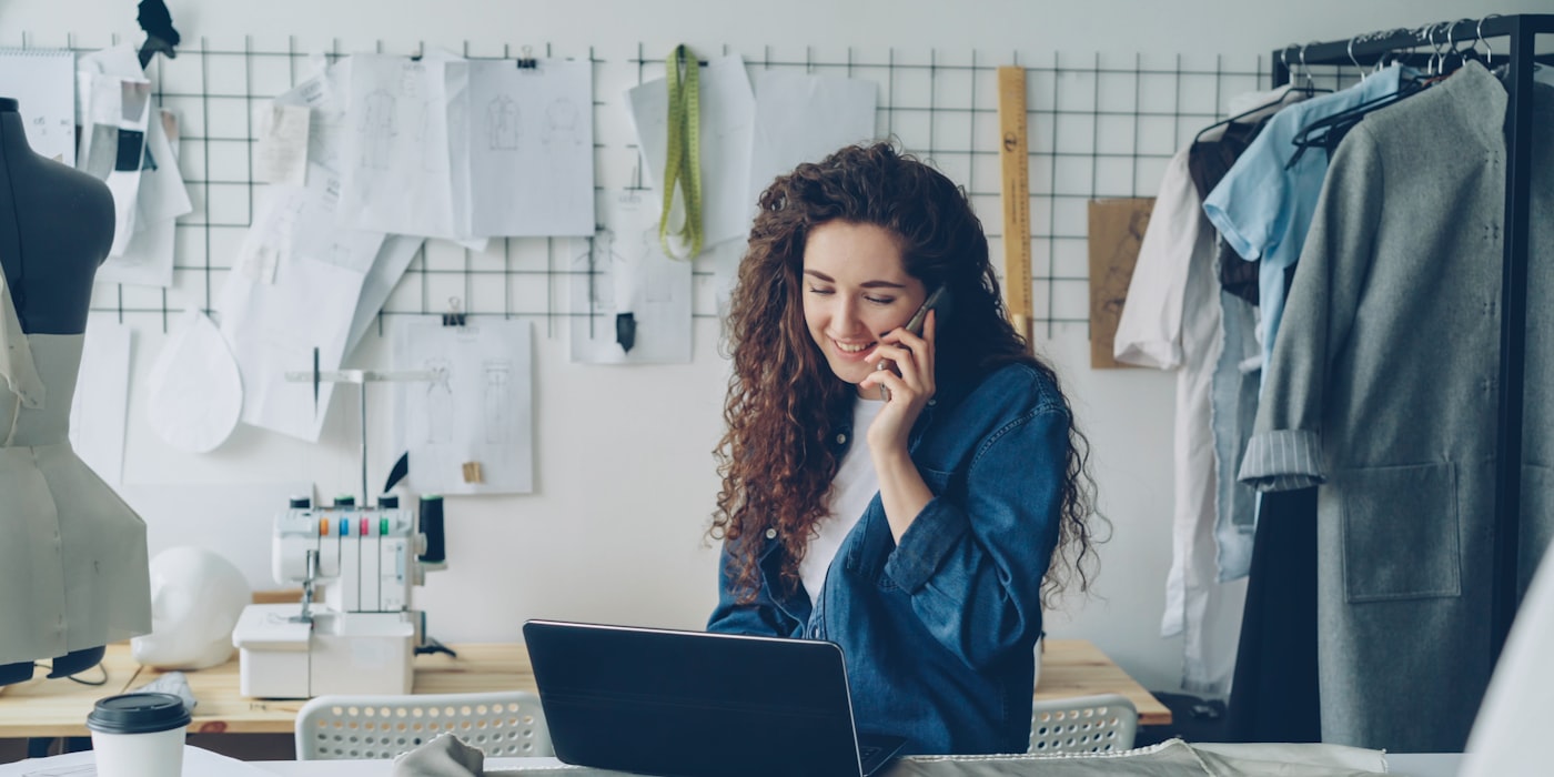 A small business owner taking a call while working