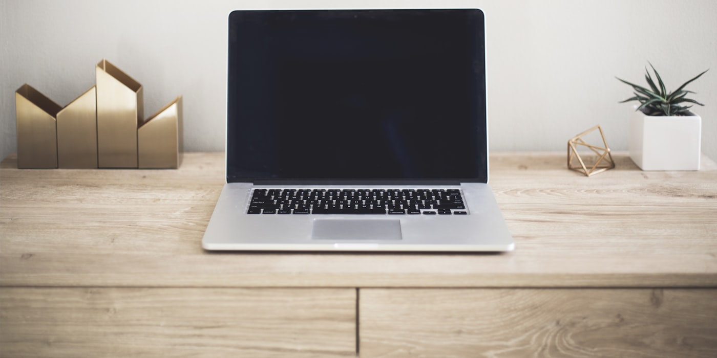 A laptop on a desk showing a website